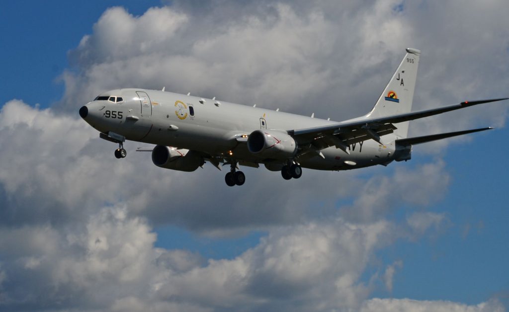 maritime patrol aircraft in front of clouds