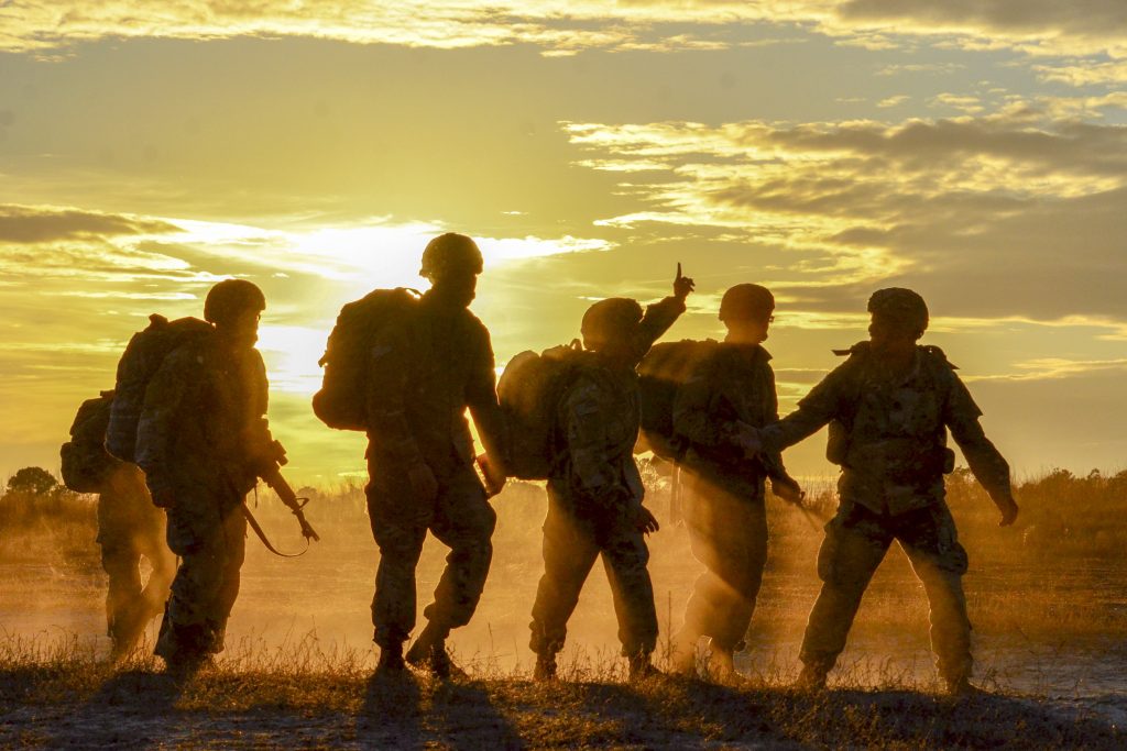 army soldiers in front of a sunset