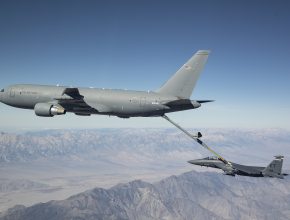 aerial tanker refueling a fighter jet above the mountains