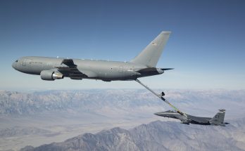 aerial tanker refueling a fighter jet above the mountains