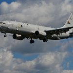 maritime patrol aircraft in front of clouds