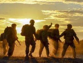 army soldiers in front of a sunset