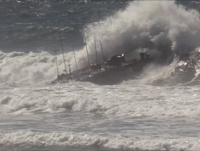 An amphibious vehicle crashes into a wave in high ocean surf