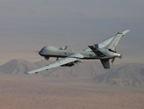 military drone flying over the desert