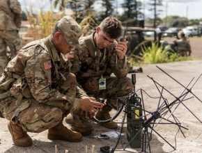 u.s. army soldiers work with a satellite ground station