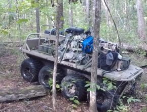 eight wheeled robotic vehicle driving through the woods