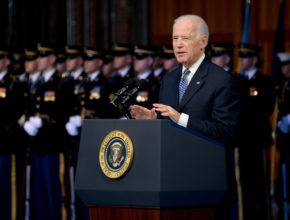 Vice President Joe Biden standing behind a podium in front of uniformed soldiers