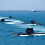 four submarines conducting group operations in blue water