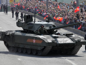 a tank drives down the street during a military parade