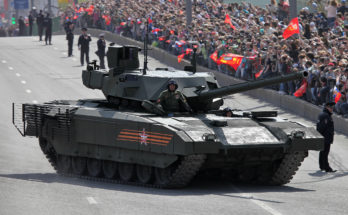 a tank drives down the street during a military parade