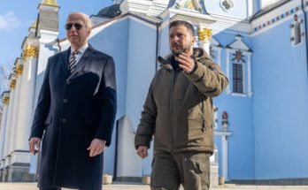 two world leaders stand in front of an ornate building in Ukraine
