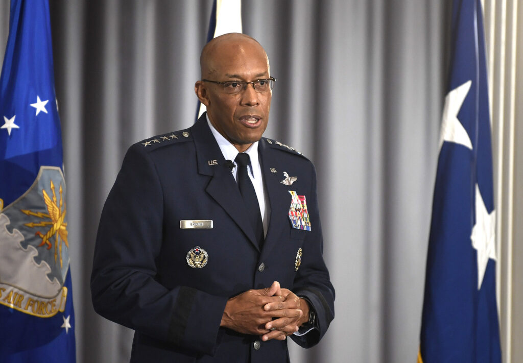 A military general stands on stage