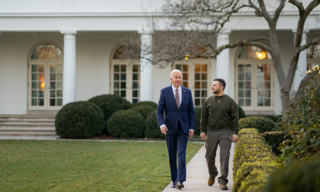 Presidents Biden and Zelensky walk along a garden path at the White House