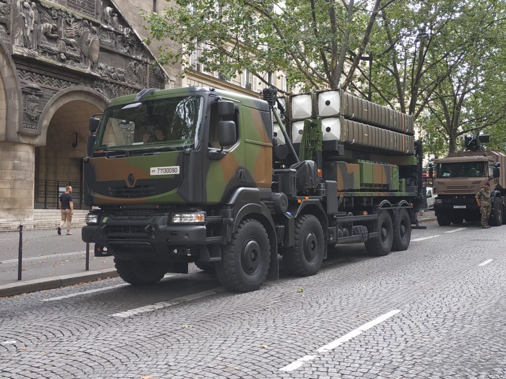 A mobile missile launcher sits on a city street 