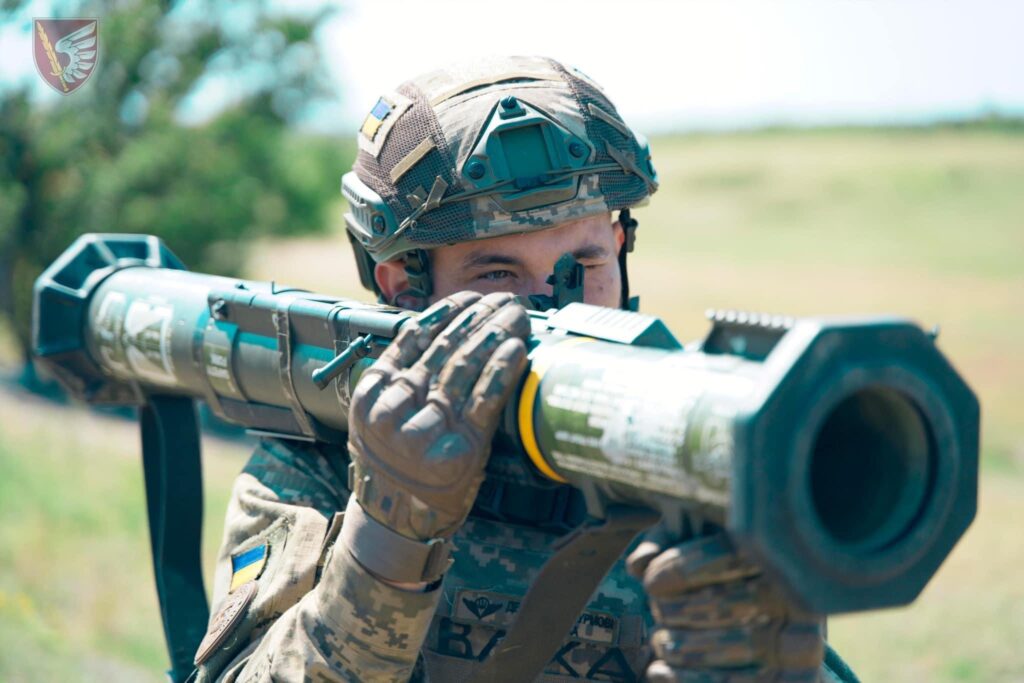 a soldier holds an anti-tank weapon on his shoulder 