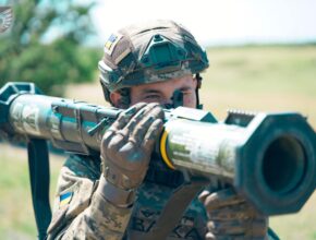 a soldier holds an anti-tank weapon on his shoulder