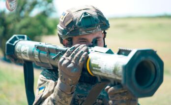 a soldier holds an anti-tank weapon on his shoulder