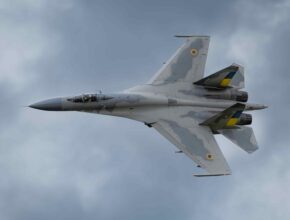 a fighter jet flies through the sky