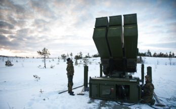 soldiers inspect a missile launcher in the snow