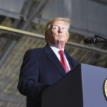 the president delivers a speech at a podium