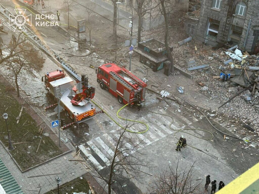 emergency vehicles parked near city rubble