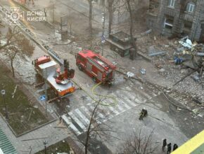 emergency vehicles parked near city rubble