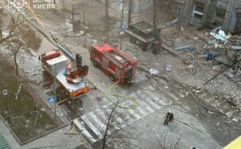 emergency vehicles parked near city rubble