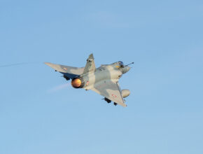 Flames erupt from a jet's engine as it takes off