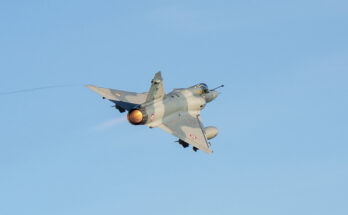 Flames erupt from a jet's engine as it takes off