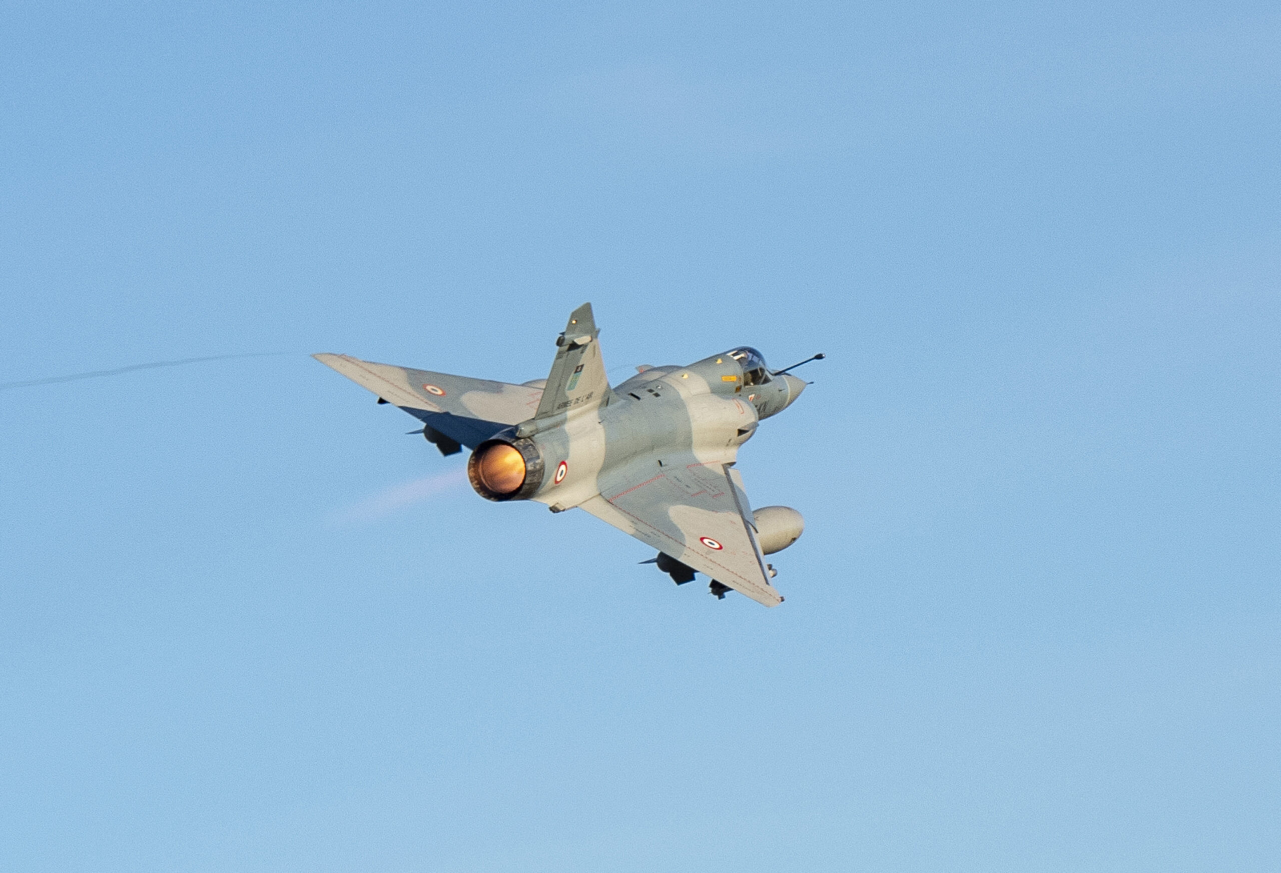 Flames erupt from a jet's engine as it takes off