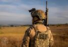 A soldier stands in a field