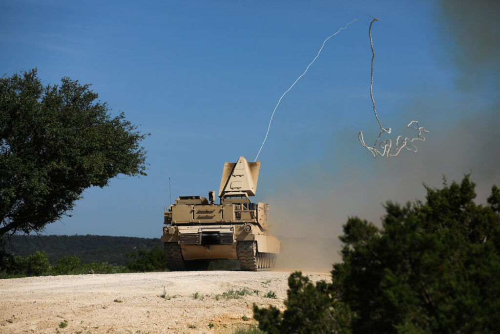 a military vehicle conducts a mine clearing exercise