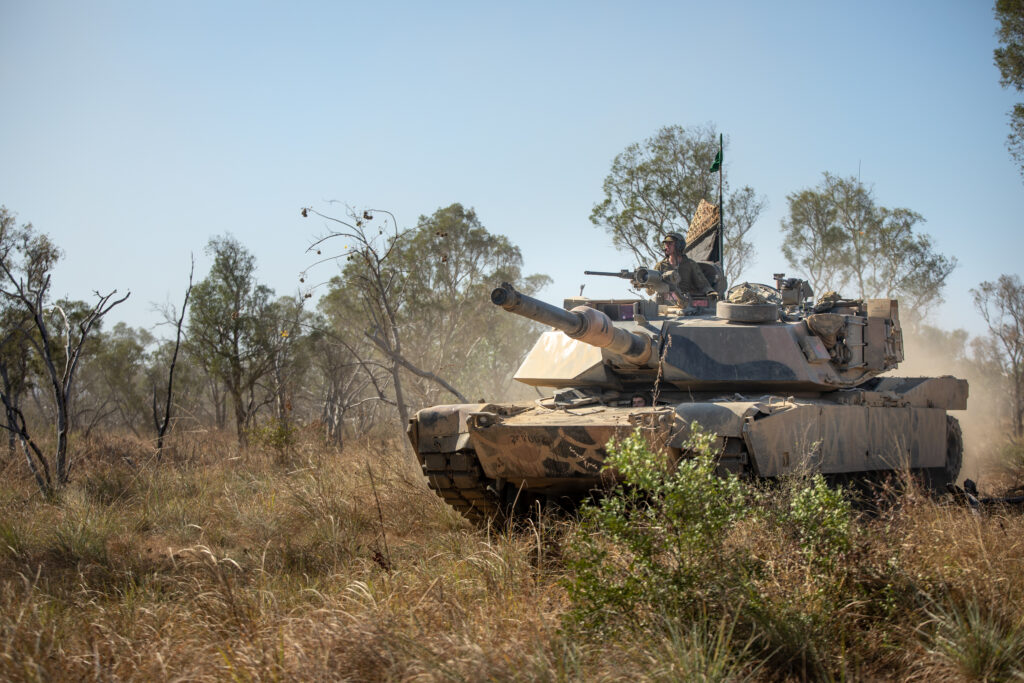 A tank drives through the Australian bush 