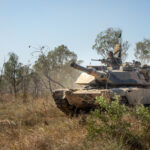 A tank drives through the Australian bush