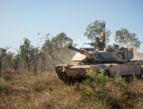 A tank drives through the Australian bush