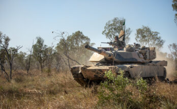A tank drives through the Australian bush