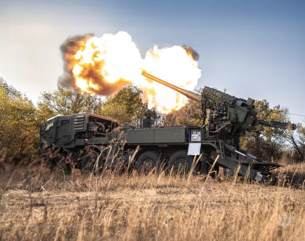 Flames erupt from the barrel of a self-propelled howitzer