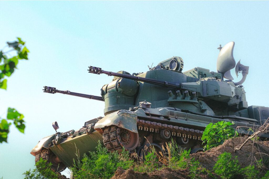 An air defense system sits on a ridge.