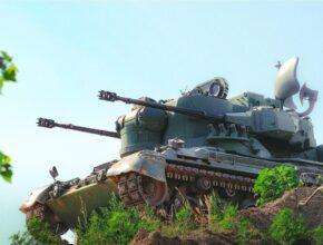 An air defense system sits on a ridge.