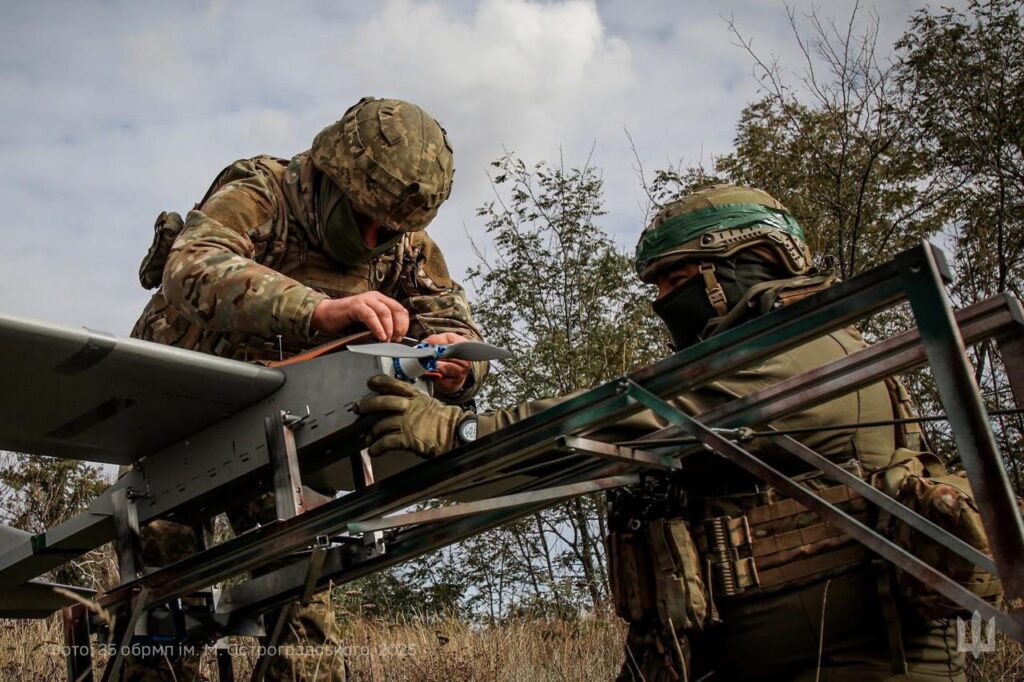 soldiers work on a drone