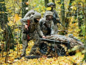 Ukrainian soldiers use a robotic vehicle in a forest