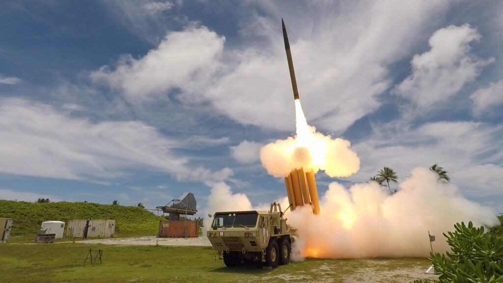 A missile is fired from a ground-based wheeled launch vehicle. 