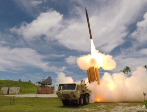 A missile is fired from a ground-based wheeled launch vehicle.
