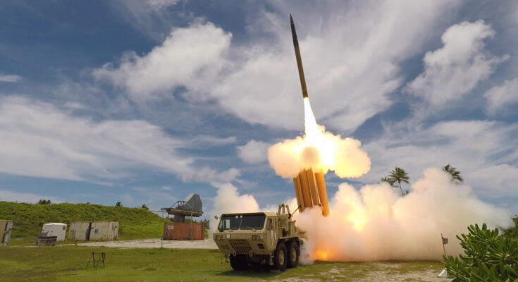 A missile is fired from a ground-based wheeled launch vehicle.